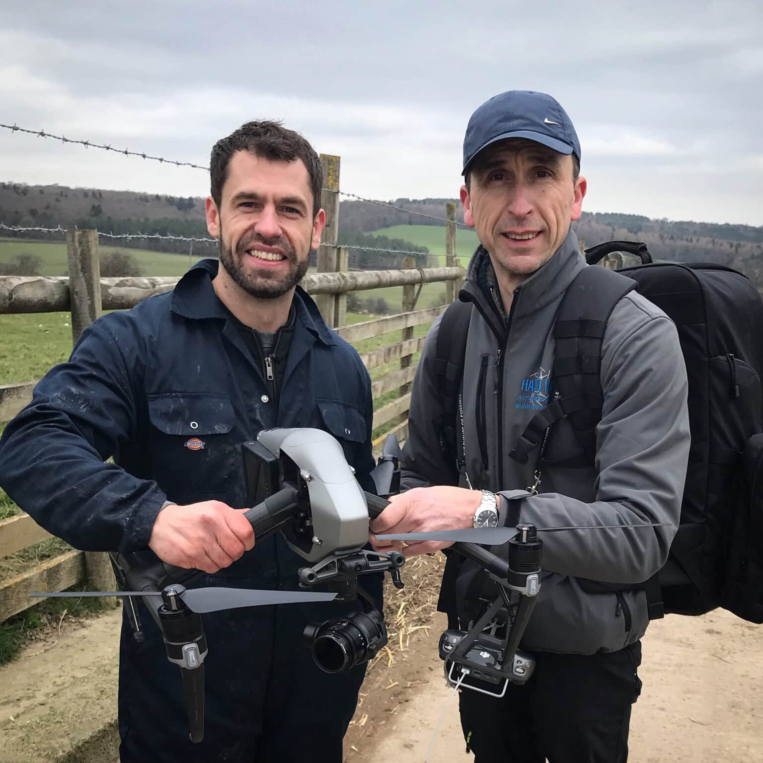 Two men holding a drone in a field on location for Channel 5's Springtime on the Farm