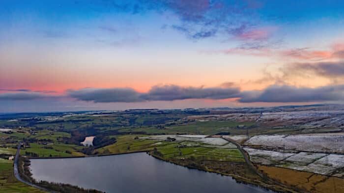 Baitings reservoir is set high in the hills above Ripponden in Calderdale West Yorkshire, surrounded by green fields and countryside.