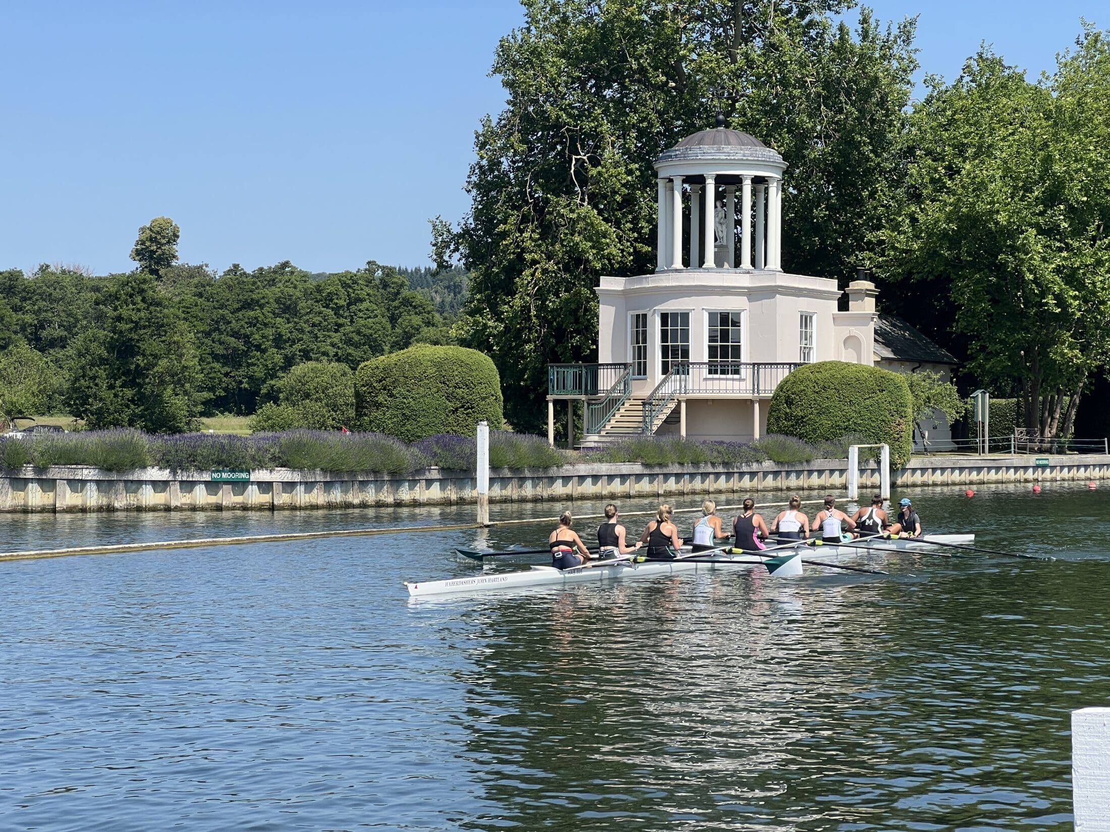 A rowing crew passing Temple Island on the Thames at the Women’s Henley Regatta