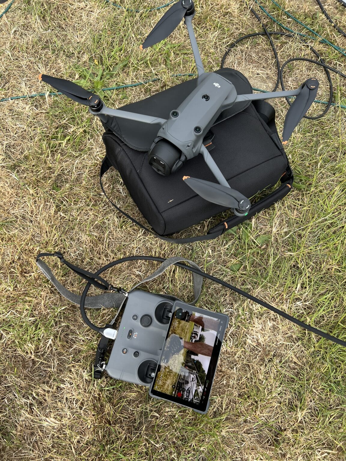 A DJI drone and controller ready at the drone base