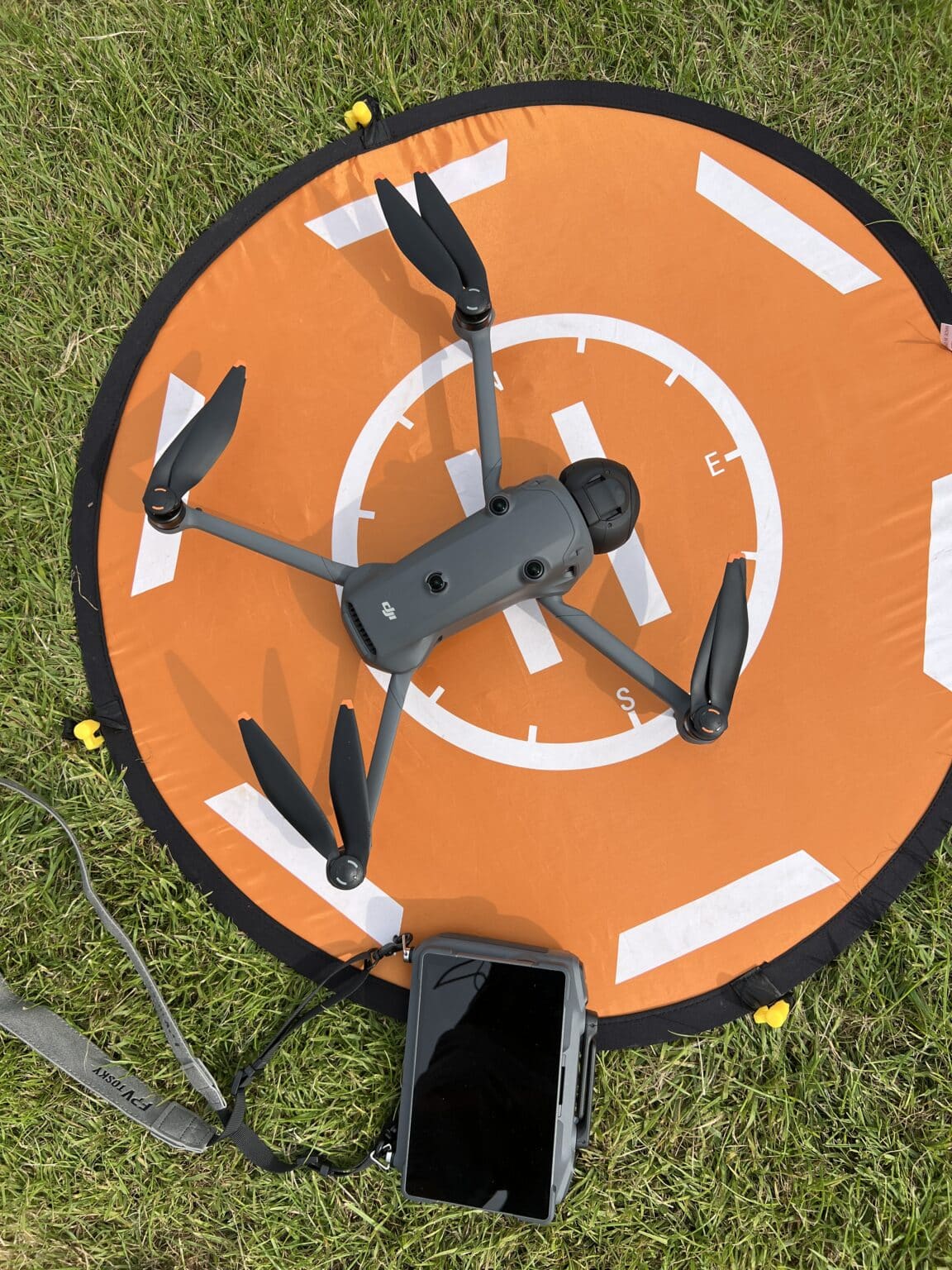 A DJI drone on its landing pad