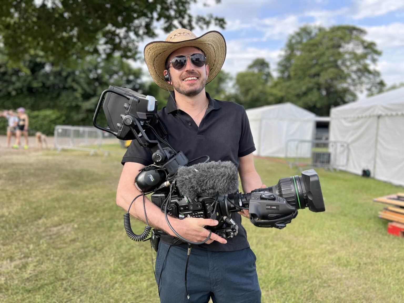 A camera operator on the riverbank
