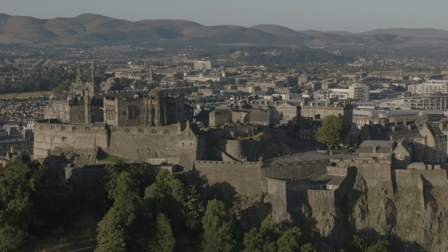 Edinburgh Castle above the city at dawn, from the air