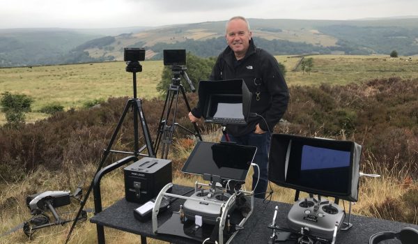 Darren Miller filming with Halo Vue, stood with Drone remote control. DJI Inspire 2 Aircraft , directors monitors in the country side