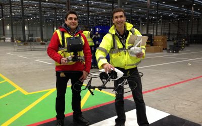 filming Indoors with a drone. Cameraman Ian Fearnley and Drone Pilot Phil Fearnley. Dressed in His Visibility safety clothing. Filming in a large warehouse